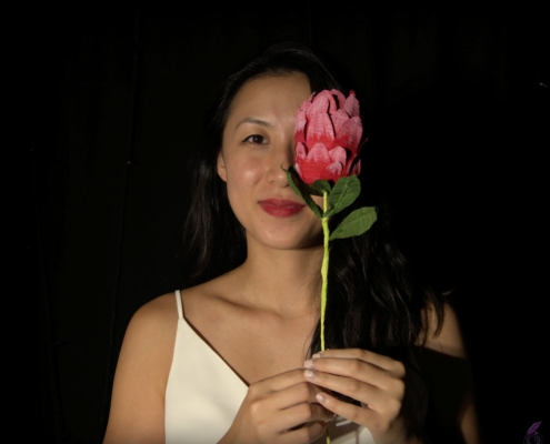 Portrait of a girl with flower, adding a pop of colour to the photograph