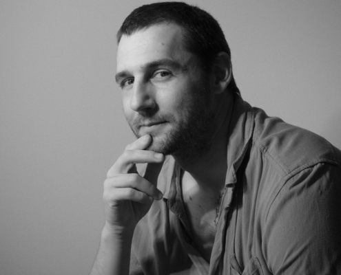 Black and white portrait of a man with his fingers on his chin