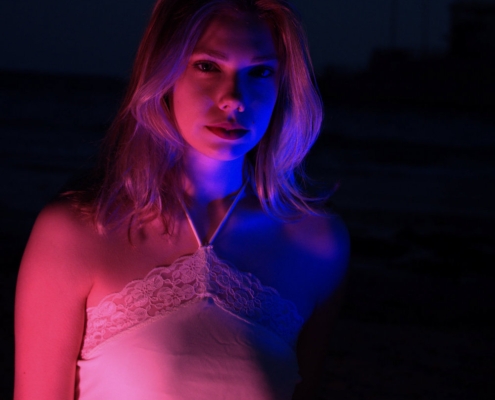 Portrait of a girl with playful pink and blue lighting