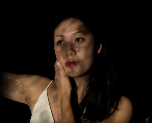 Portrait of a young lady with lace casting shadows on her face