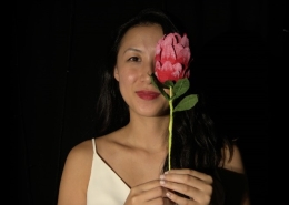Girl with flower, adding a pop of colour to the photograph